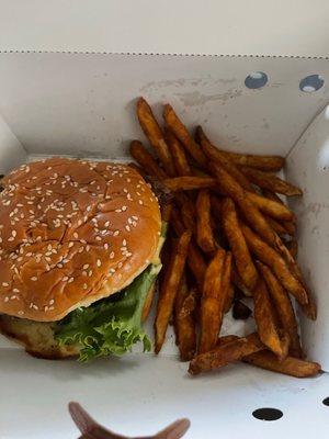 Burger and seasoned fries.