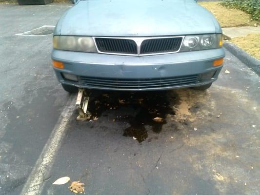 A car that was left to spill oil everywhere after being worked on a month ago.