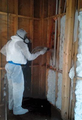 Spraying Open-Cell Spray Foam within walls.