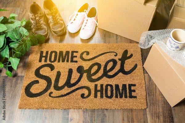 Entry of a home with a rug that says "Home Sweet Home"