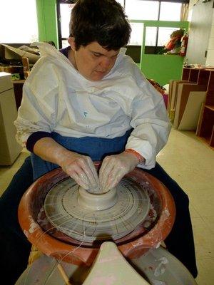 Kelly Brown throwing on the wheel in our ceramics studio