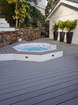 Custom trex deck and fascias, drop-in jetted tub with led light, step lights and white trex fascia.