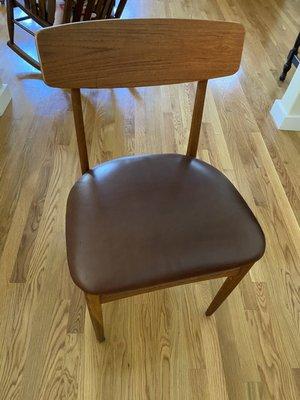 Dining chair reupholstered in leather.