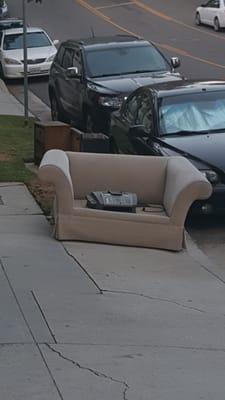 More discarded furniture in front of building