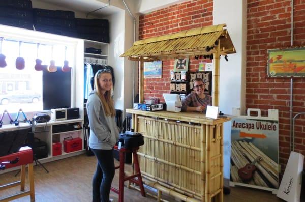 Ashley the employee (who knows her ukuleles!) at the counter/checkout/cash register with my daughter. We loved the Tiki bar for the counter.