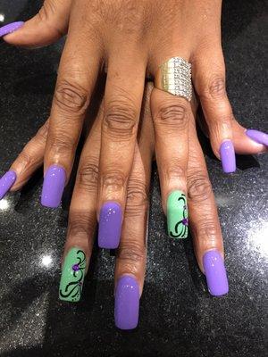 Medium length purple and teal with designs on the ring finger