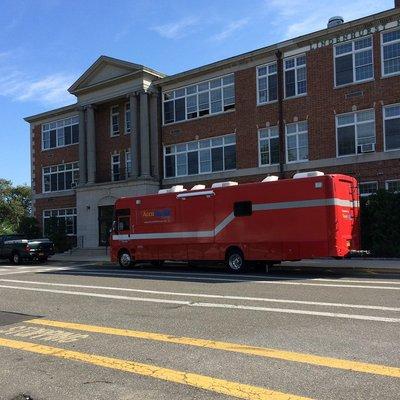 Our Medical RV parked at LIndenhurst Middle School conducting Health and Wellness Exams