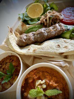 Adana kebab with muhammara & shakshuka