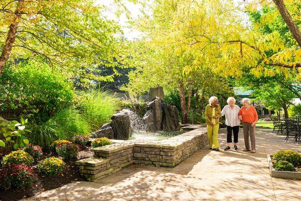 Residents walking through the gardens of Springhouse