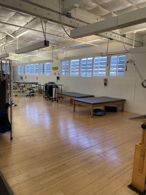 Large open space with more equipment and several stretching areas. Mirrors help you evaluate your posture