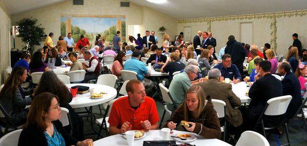 Enjoying a meal in our Fellowship Hall