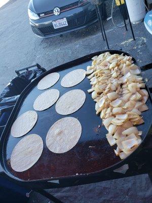 Getting tortillas and onions ready for tacos