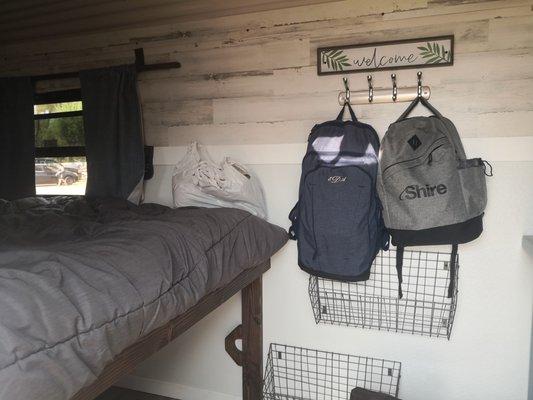 Interior storage hookup and shoe storage area near bed.