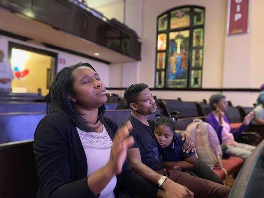 Family praying at Corporate Prayer Night