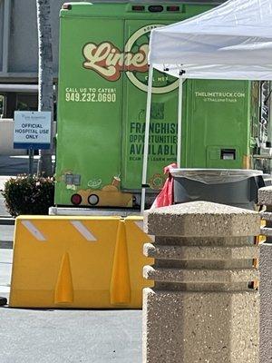 Back of food truck with phone number, website, and social media handle