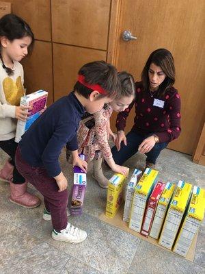 Gan Elohim preschoolers help sort and count donations for Family Table.