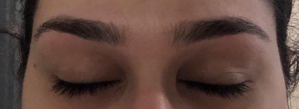 Eyebrows are uneven and not shaped properly.