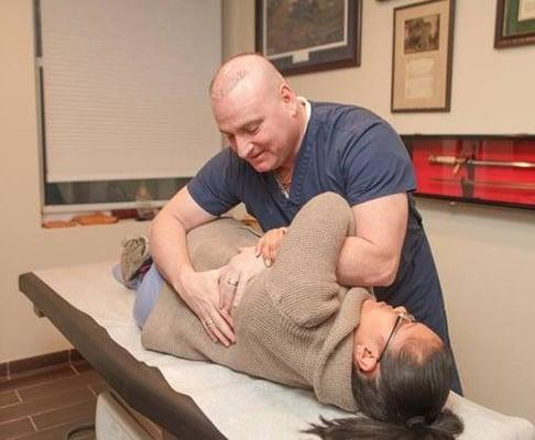 Dr. Tommy O treating pain with Osteopathic Manipulation.