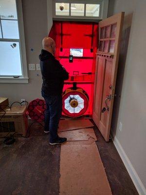 Founder, Jon Gensler, monitoring the data on a blower door test