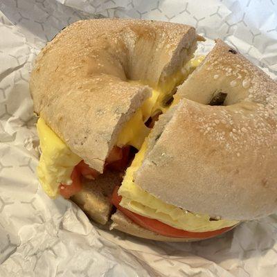 Eggwich on a jalapeño cheese bagel with tomato and onions.