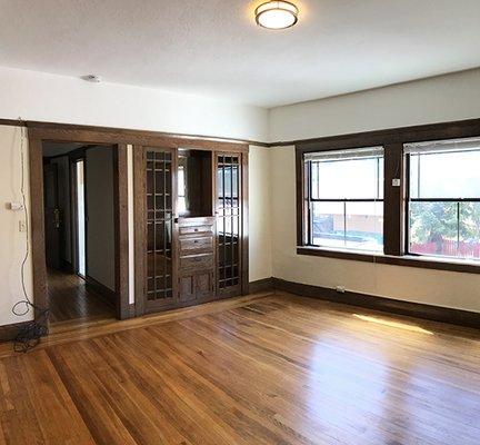 Main room with built-in glass-front shelves