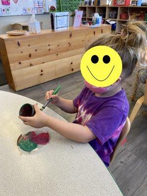 My daughter, painting a pot.