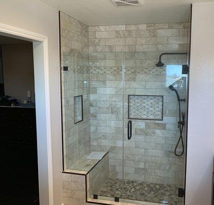 Brand new shower, tile and glass doors installed where customer previously had a tub