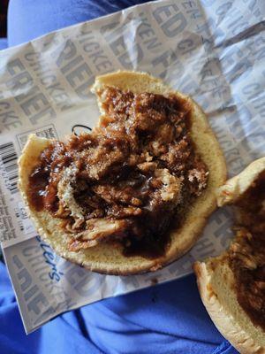 Hardly enough BBQ chicken to cover bread.