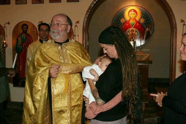 Father Wayne Wilson at the end of a baptism service.