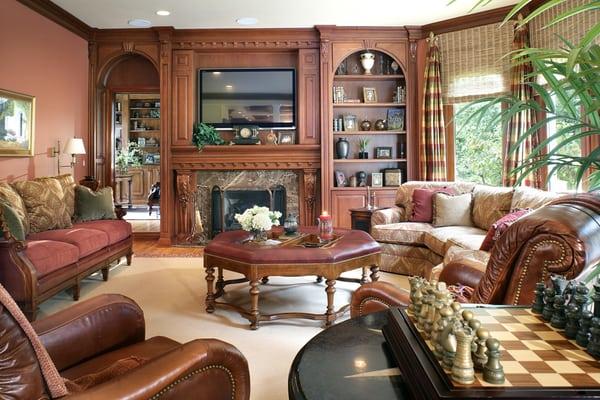 Family room renovation.  redesigned the fireplace/TV wall  in warm wood with detail, new marble and TV above, new furniture.