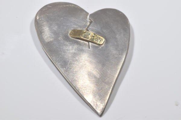 Sterling Silver and 18k yellow gold broken heart pin.