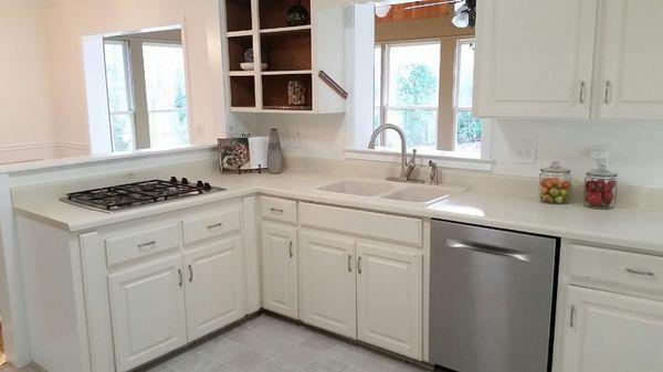 Brand new range installed, painted walls, removal of 70s backsplash, and all new hardware