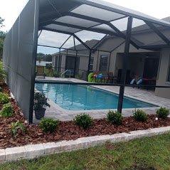 Newly installed retaining wall, mulch and plants.