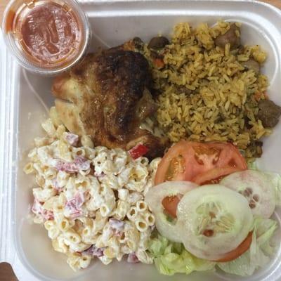 The Rotisserie chicken combo served with rice and sausages (arroz con salchichas), macaroni salad and a green salad