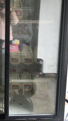 Dirty moldy milk fridge that has a seal problem.