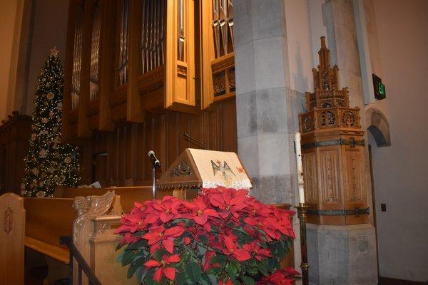 Lectern decorated with poinsettias. (2019)