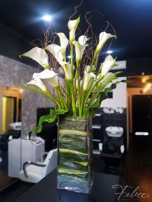 Calla lilies and curly willow compliment the salon setting