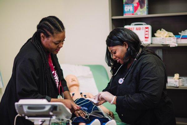 Our M.A. (Medical Assistant Program). Student receiving one on one instruction.