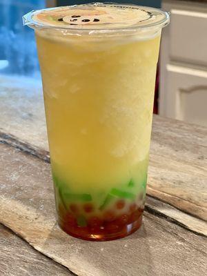 Pineapple blended with green apple jelly and popping strawberry boba