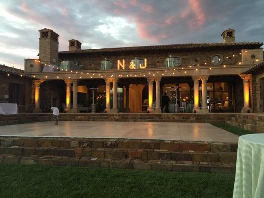 Cafe Lights in Amber over the dance floor and hung over the whole reception area with LED accent lights in Warm Amber on the home.