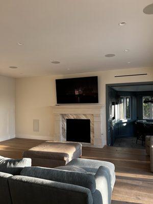 85" TV above fireplace with a 7.1.2 Dolby Atmos Surround Sound System Controlled by Savant.