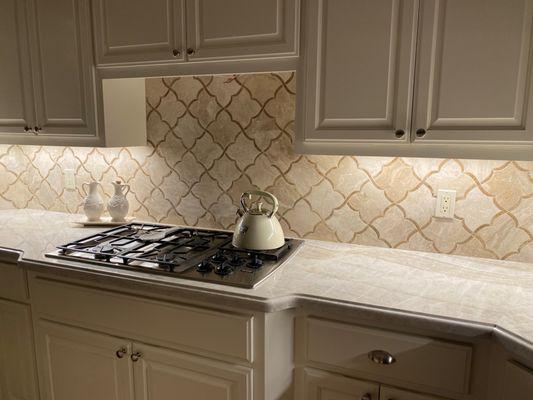 Taj Mahal countertop with Ogee Flat edge detail. Finished with a marble waterjet backsplash