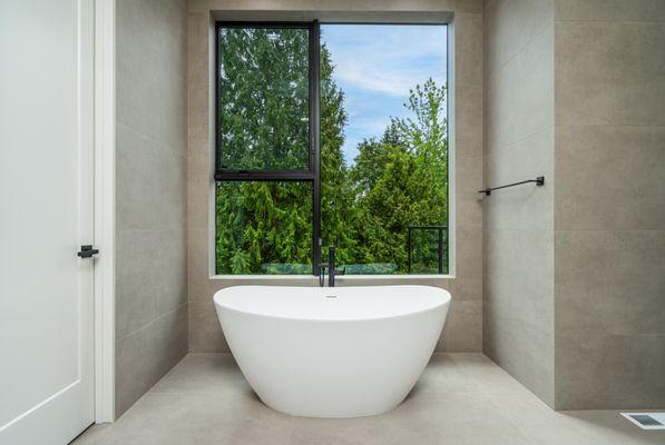 Simple, modern bathroom with a sleek design, custom made for our clients in Bellevue. Our custom home design includes a gorgeous view.