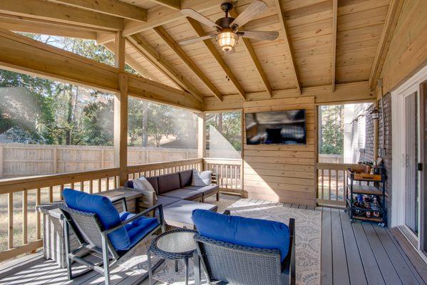 TV wall included in this screen porch by Light Box Homes