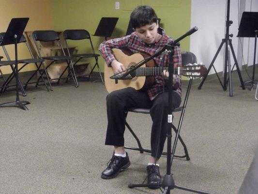 Student playing classical guitar