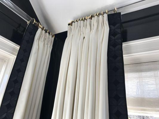 Drapery on custom lucite poles with custom brass hardware.