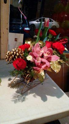 Symbidium, tulips, roses Christmas arrangement.