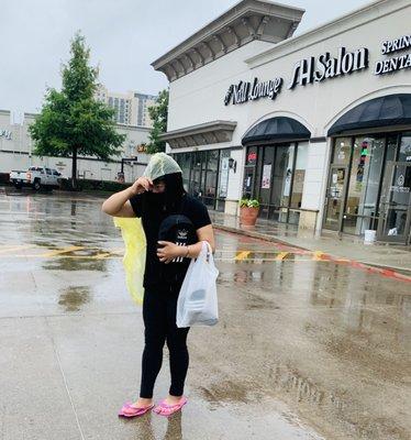 Complimentary disposable raincoat, Soho Nail Lounge - in front of Nordstrom Rack.