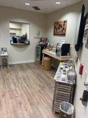 The waiting room with coffee bar and treats such as soda, water, tea, cookies, trail mix, crackers, chips, and chocolates.