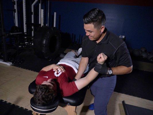 Dr. EROD working on an athlete's sore shoulder.